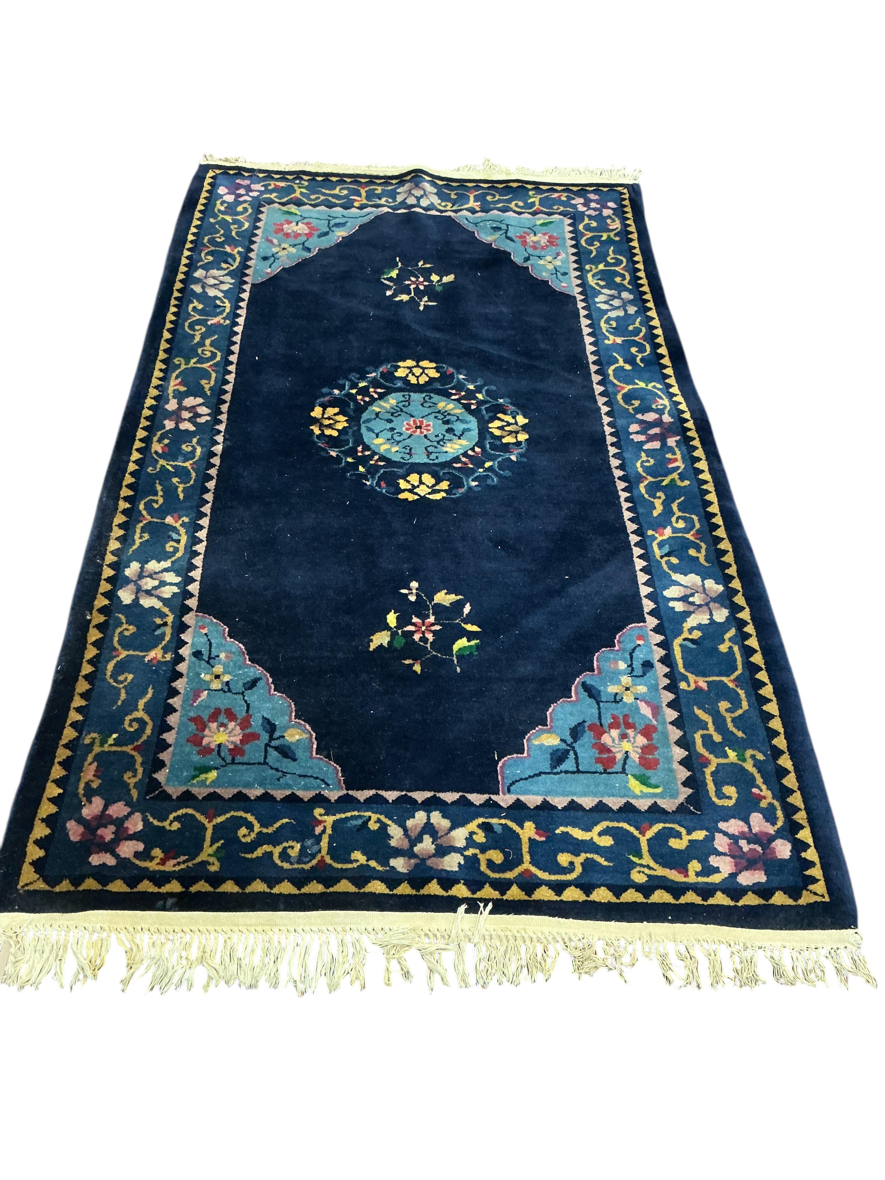 A Chinese blue ground rug, 210 x 120cm